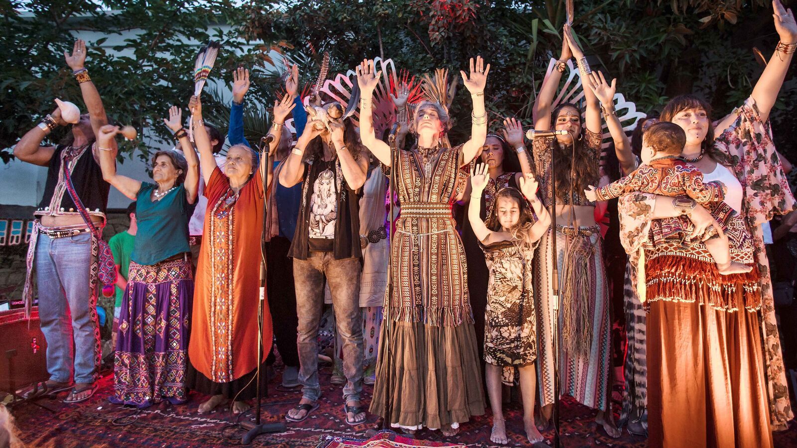 Stalls of the Las Dalias hippy market with clothes and crafts in warm Ibiza light